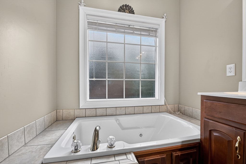 220 Oak Rdg Lane Ellijay, GA 30536 - Photo 18 of 36 a bathroom with a bathtub and a window