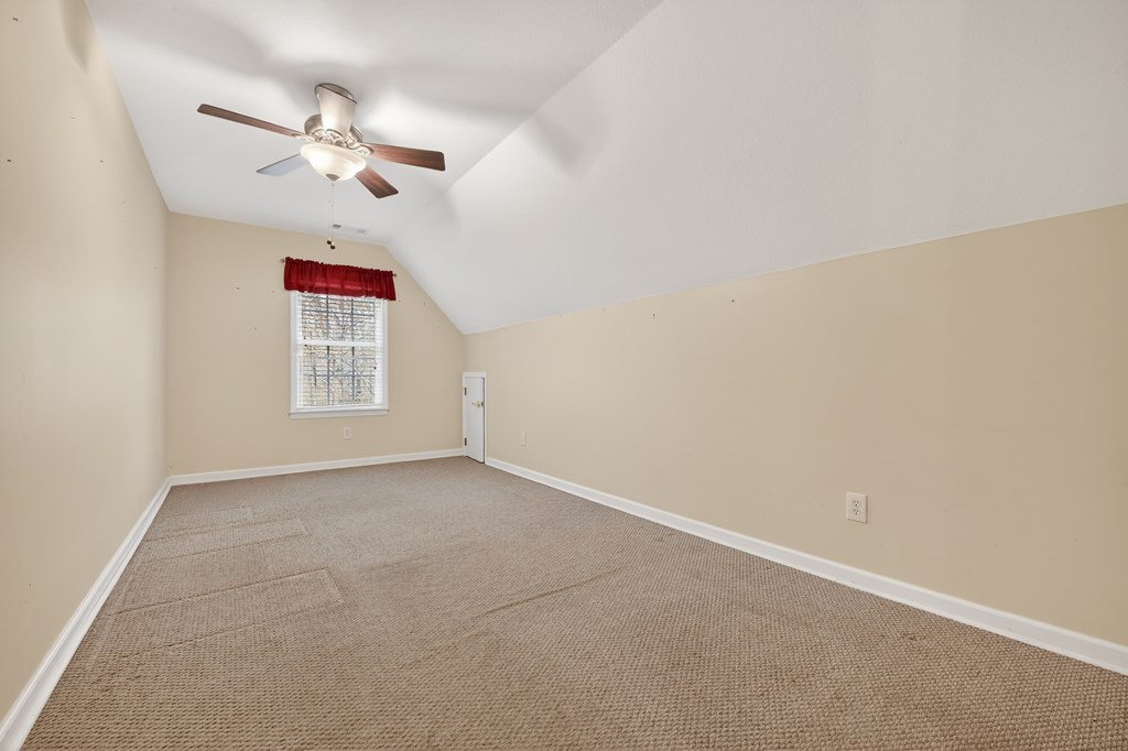 220 Oak Rdg Lane Ellijay, GA 30536 - Photo 25 of 36 en empty room with windows and chandelier fan