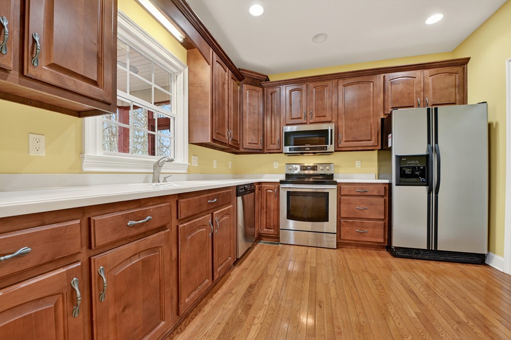220 Oak Rdg Lane Ellijay, GA 30536 - Photo 7 of 36 a kitchen with granite countertop wooden floors stainless steel appliances and sink