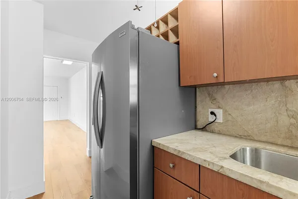 a kitchen with a refrigerator and a sink