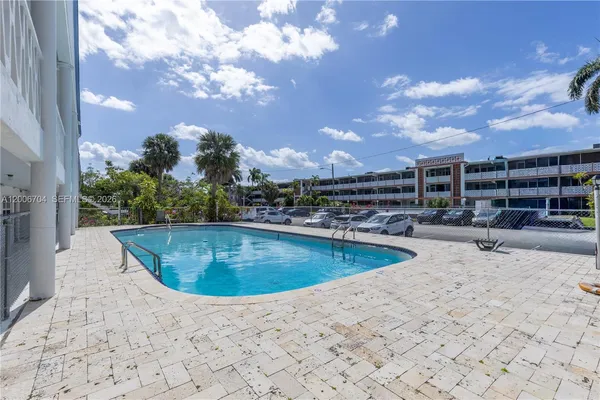 a view of a swimming pool with outdoor seating