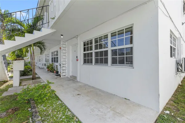 a view of front door of house with stairs