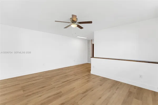 a view of a room with wooden floor