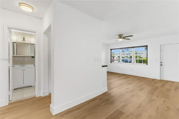 an empty room with windows and closet