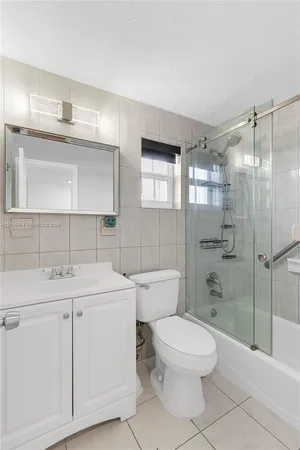 a bathroom with a toilet sink and shower