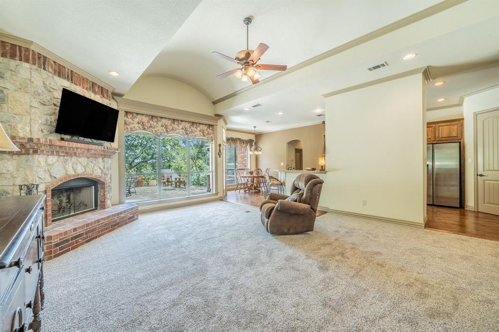 109 Overton Ridge Circle Weatherford, TX 76088 - Photo 5 of 27 Open concept to kitchen and dining. Windows to enjoy the patio from inside.