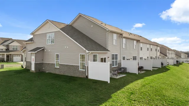 a front view of a house with a garden and yard