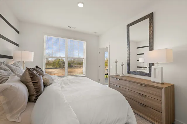 a bed room with a bed and a night stand