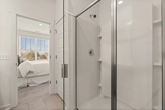 a bathroom with a glass shower door and a sink