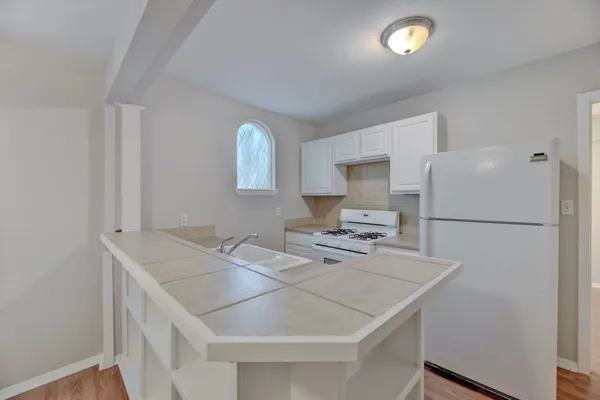 a kitchen that has a table and a stove in it