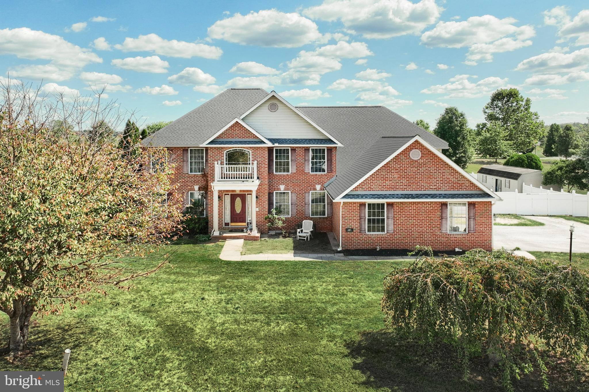 a front view of a house with yard and green space