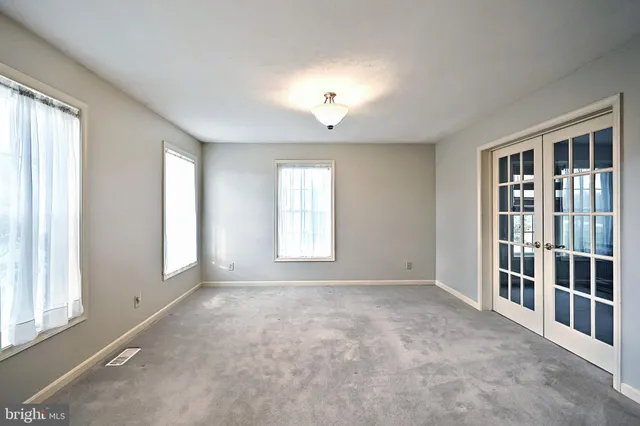 a living room with furniture a fireplace and a chandelier