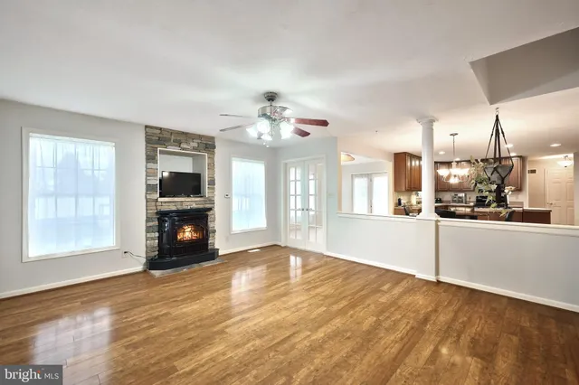 a dining room with furniture a chandelier and window