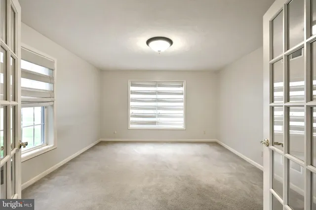 a dining room with furniture a chandelier and a rug