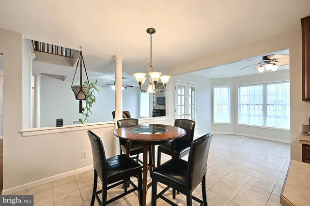 a kitchen with stainless steel appliances kitchen island granite countertop a table chairs and a wooden cabinets