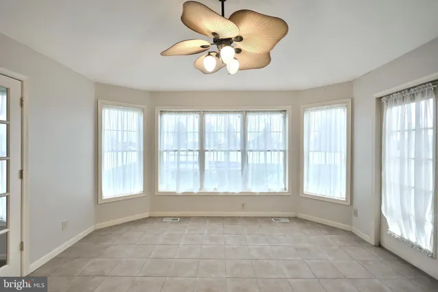 a large kitchen with stainless steel appliances granite countertop a refrigerator stove a sink and dishwasher