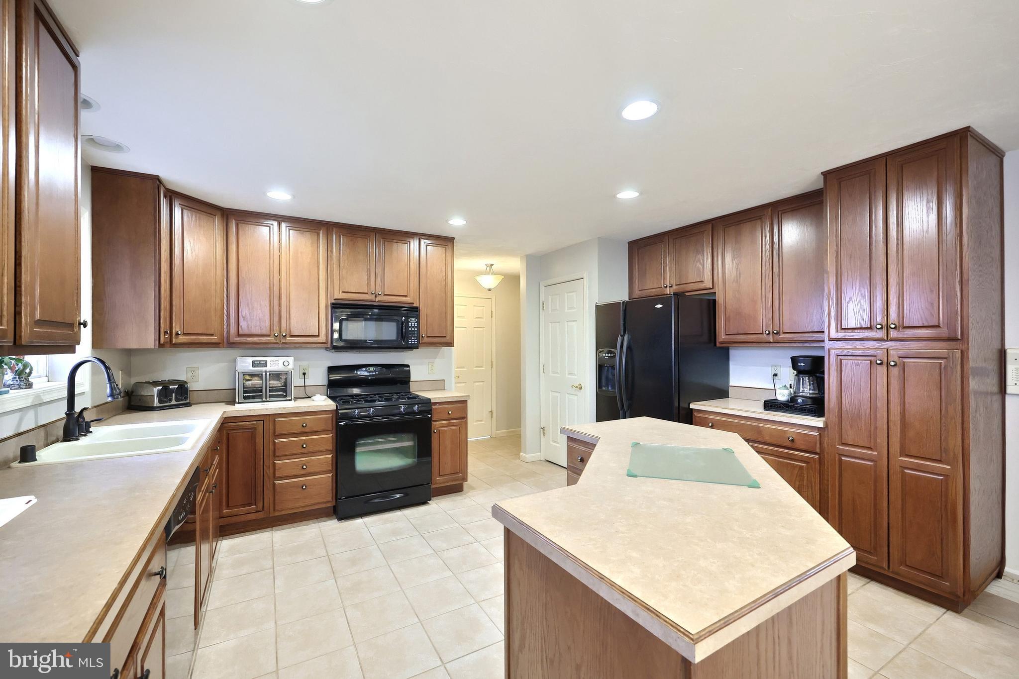 37 Amanda Drive Littlestown, PA 17340 - Photo 31 of 70 a large kitchen with stainless steel appliances granite countertop a refrigerator stove a sink and dishwasher
