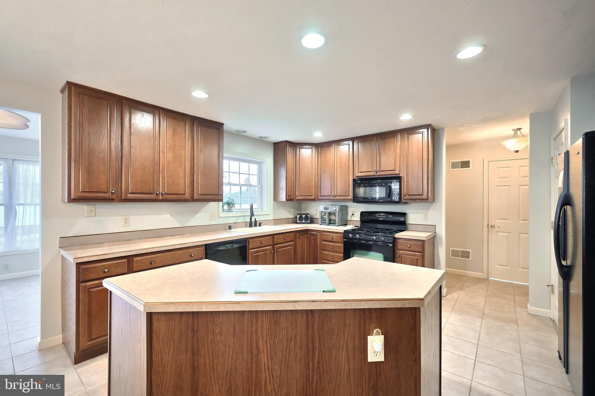 37 Amanda Drive Littlestown, PA 17340 - Photo 32 of 70 a kitchen with a sink a counter top space stainless steel appliances and cabinets