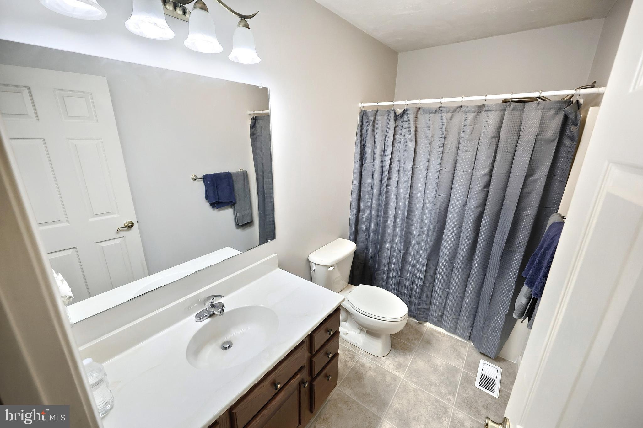 37 Amanda Drive Littlestown, PA 17340 - Photo 44 of 70 a bathroom with a sink a toilet a mirror and shower curtain