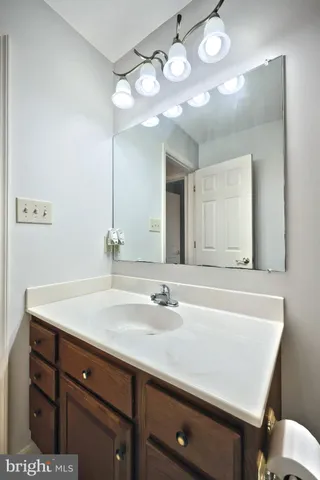 a bathroom with a tub a sink and a window