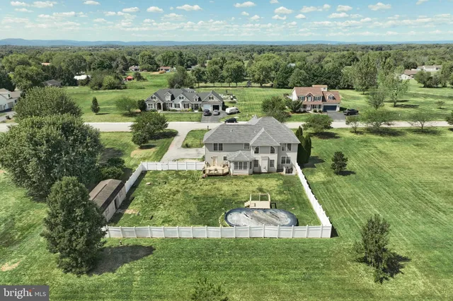 a view of a house with a yard and lake view