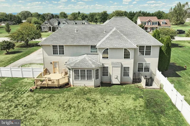 an aerial view of a house with a yard table and chairs