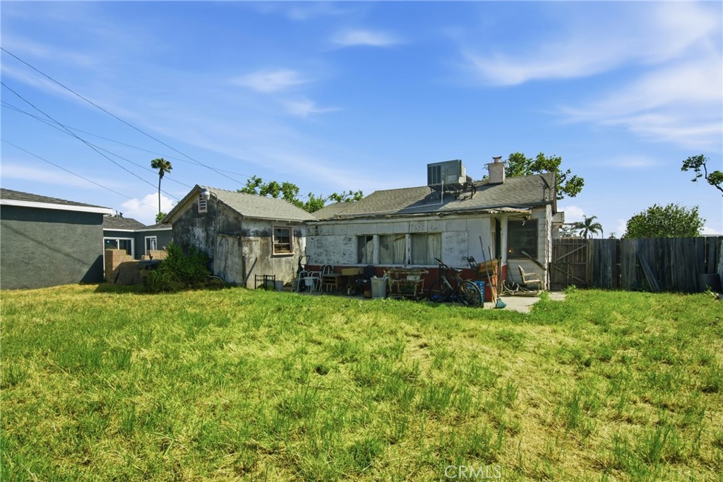 615 North Grandee Avenue Compton, CA 90220 - Photo 11 of 14 a view of a house with a big yard potted plants and large tree