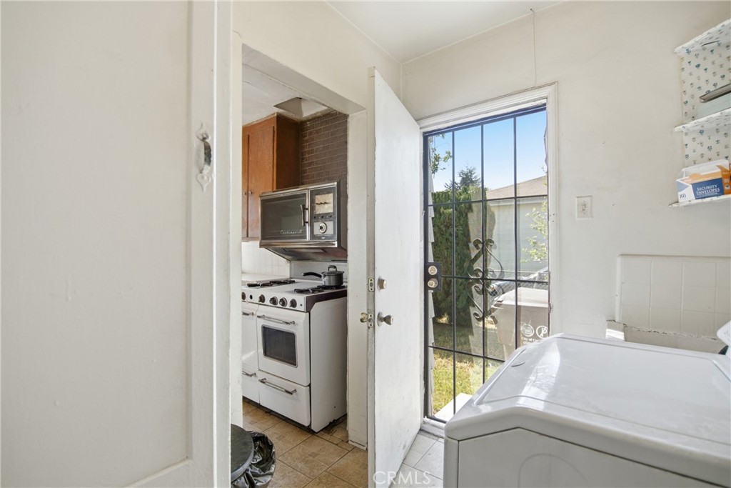615 North Grandee Avenue Compton, CA 90220 - Photo 6 of 14 a kitchen with stainless steel appliances granite countertop a refrigerator and a stove