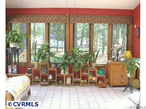 5321 Copperpenny Road Chesterfield, VA 23832 - Photo 4 of 10 a living room with furniture a floor to ceiling window and a potted plant