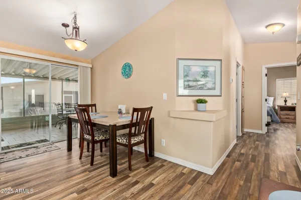 a view of a bedroom with wooden floor and bathroom