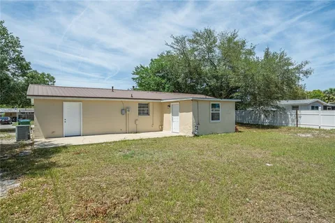 front view of a house with a yard and a garage