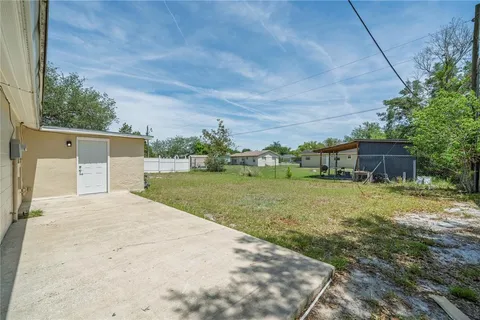 a view of a house with a yard and a garage