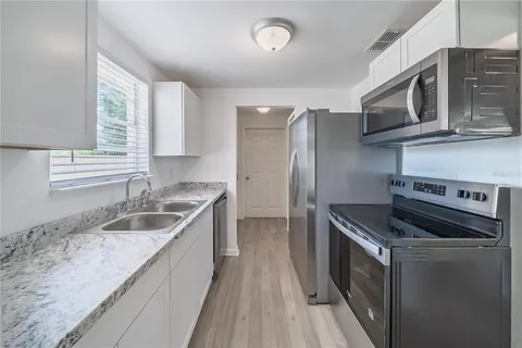 a kitchen that has a sink and a stove