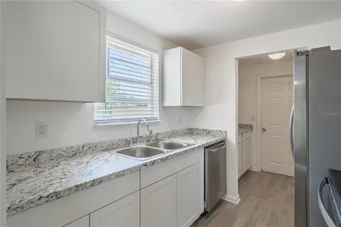 a kitchen with a sink and a wooden cabinets