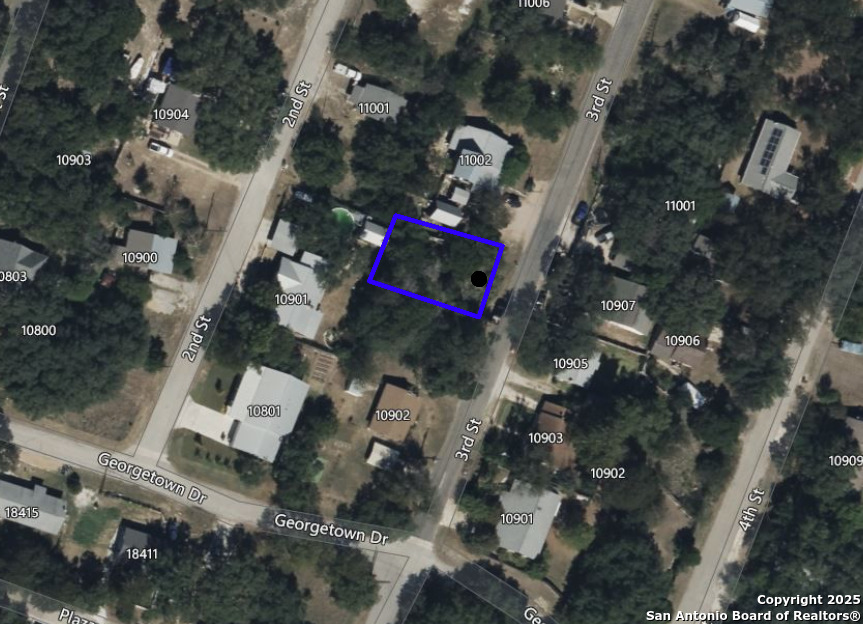 10906 3rd Street Jonestown, TX 78645 - Photo 9 of 9 an aerial view of a house with a yard and parking