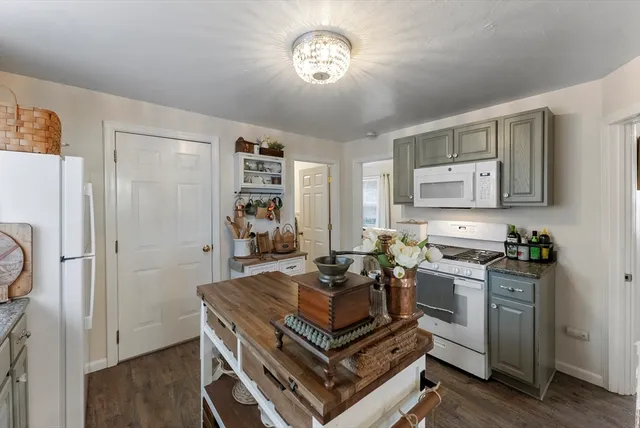 a kitchen with a refrigerator and a stove top oven