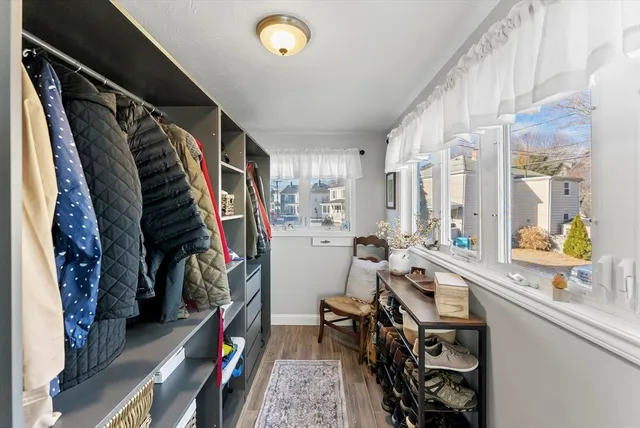 a view of walk in closet with clothes and shoes
