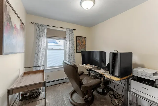 a living room with furniture a window and gym equipment
