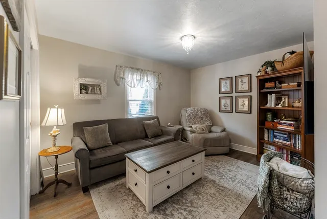 a living room with furniture and a book shelf