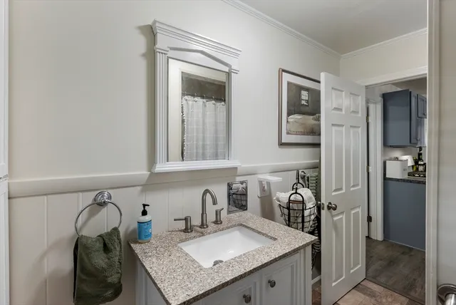 a kitchen with a granite countertop sink and cabinets