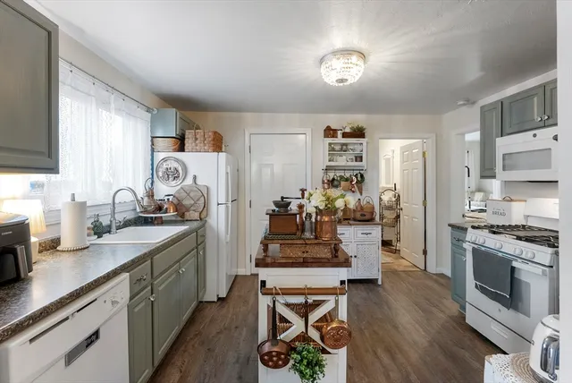 a kitchen with stainless steel appliances a stove a refrigerator and cabinets