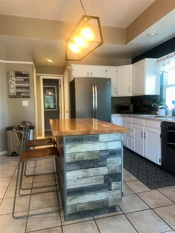 a living room with a rug and a flat screen tv
