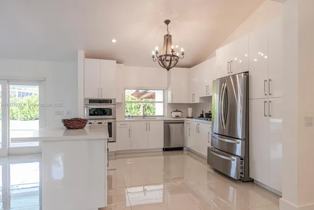 a kitchen with stainless steel appliances a refrigerator sink and microwave