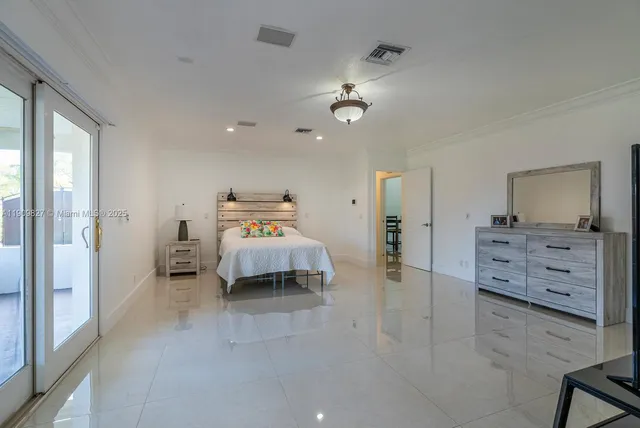 a bedroom with furniture and a mirror