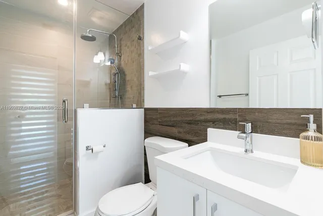 a bathroom with a sink toilet and shower