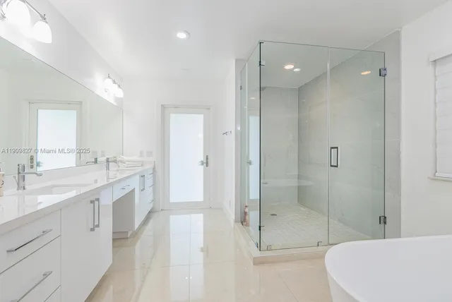 a bathroom with a double vanity sink toilet and shower