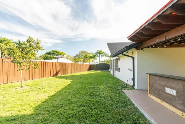 a view of house with yard and entertaining space