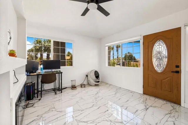 a living room with furniture a window and a clock