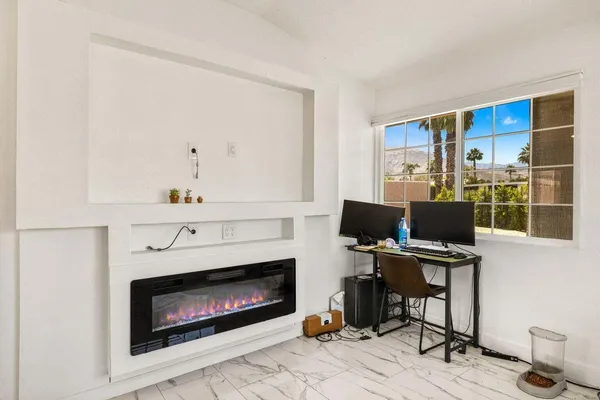 a workspace with a fireplace and a window