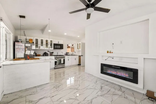 a open kitchen with cabinets and stainless steel appliances